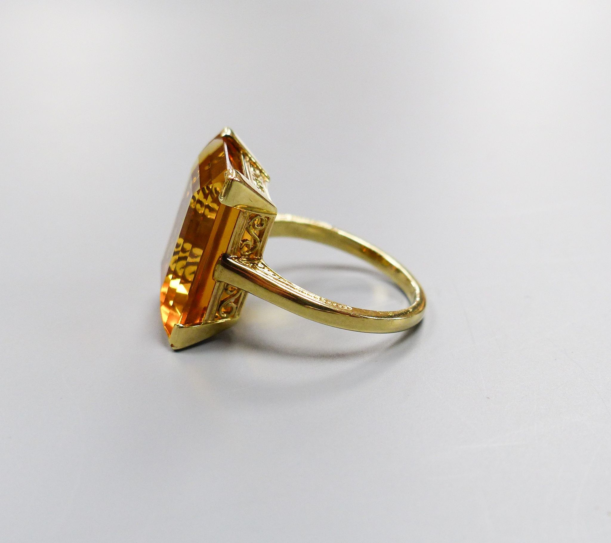 A modern yellow metal and emerald cut citrine set dress ring, size K, gross weight 6.6 grams.